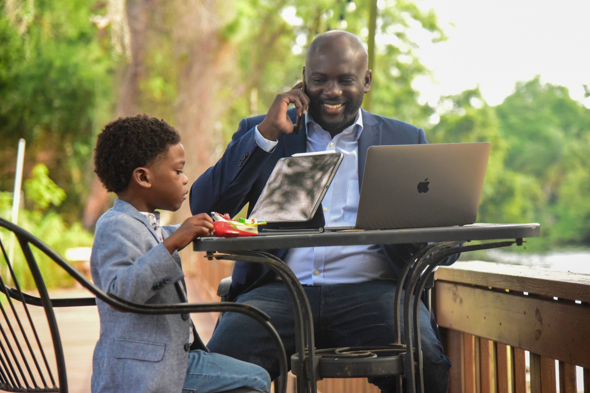 Brown working lakeside with his son