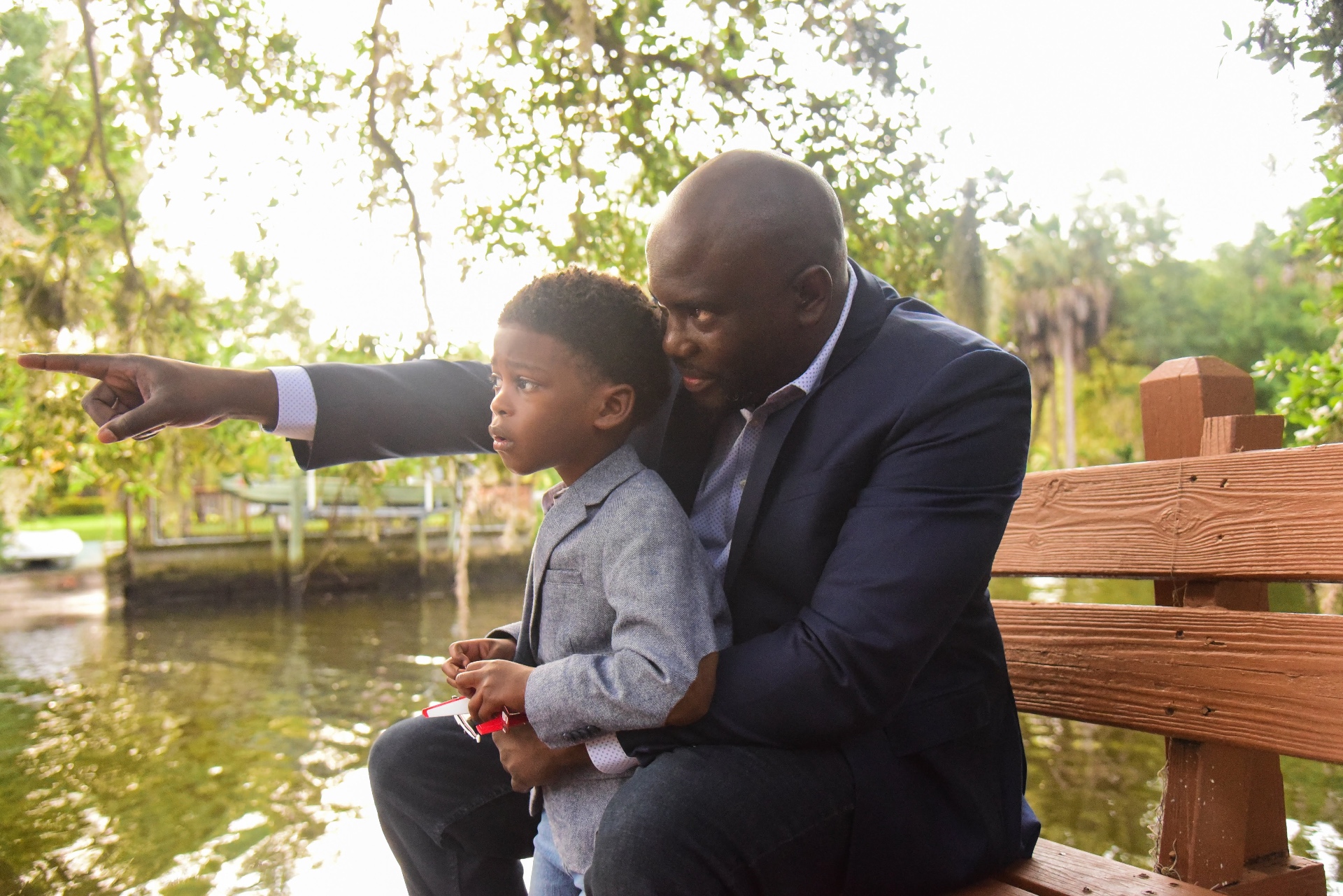 Brown teaching his son on the dock